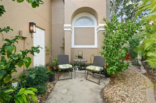 a view of a house with a chairs and potted plant