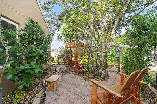 a view of a backyard with sitting area