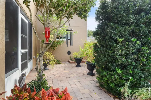 a front view of a house with a yard and potted plants