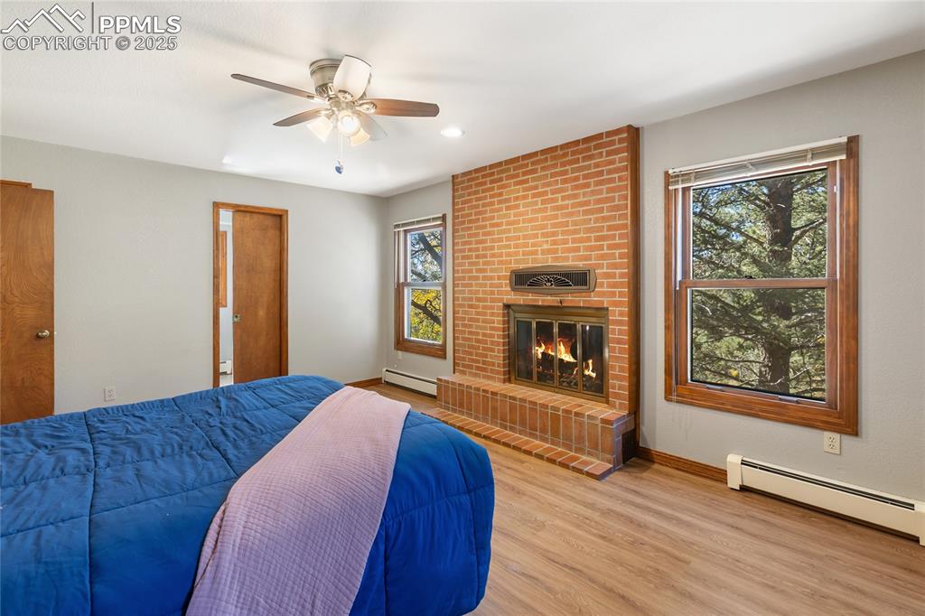 356 Spring Valley Drive Divide, CO 80814 - Photo 22 of 50 a bedroom with a bed and a fireplace