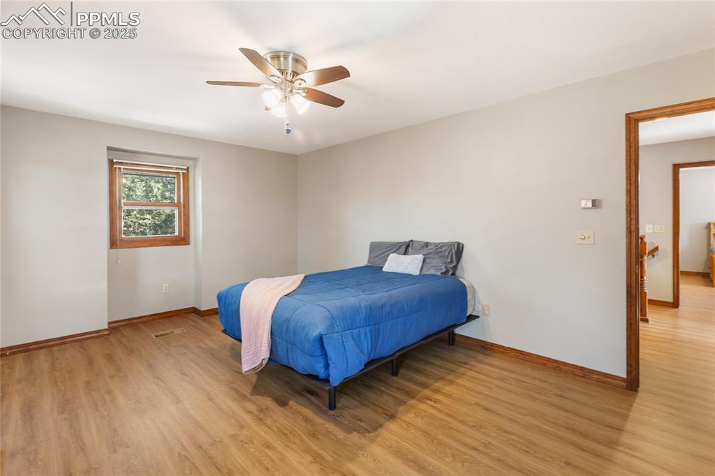 356 Spring Valley Drive Divide, CO 80814 - Photo 24 of 50 a bedroom with a bed and wooden floor