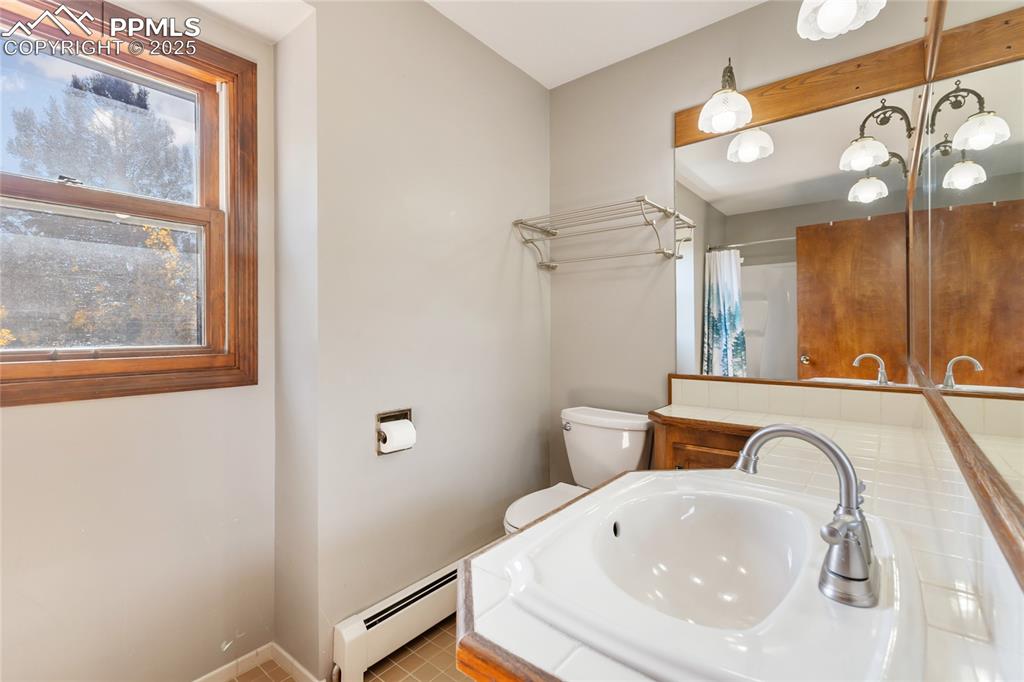 356 Spring Valley Drive Divide, CO 80814 - Photo 30 of 50 a bathroom with a sink a mirror and a bathtub