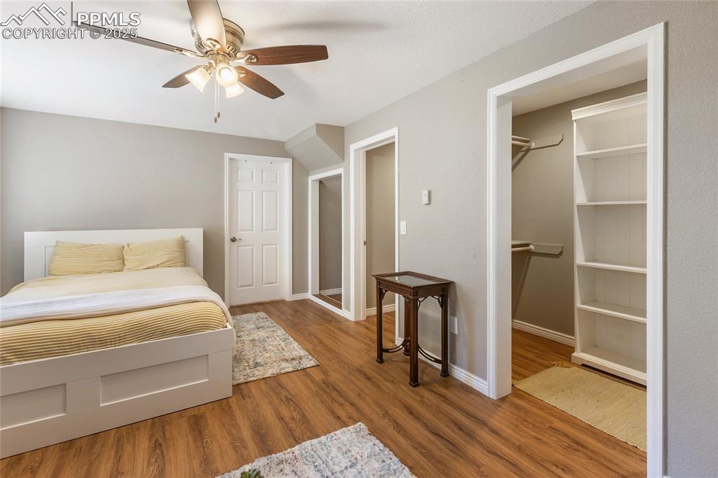 356 Spring Valley Drive Divide, CO 80814 - Photo 36 of 50 a bedroom with a bed and a chandelier