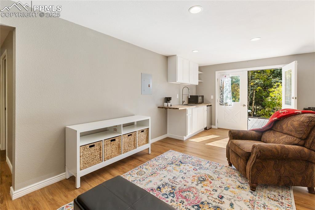 356 Spring Valley Drive Divide, CO 80814 - Photo 39 of 50 a living room with stainless steel appliances kitchen island granite countertop a refrigerator a stove top oven and a dining table with wooden floor