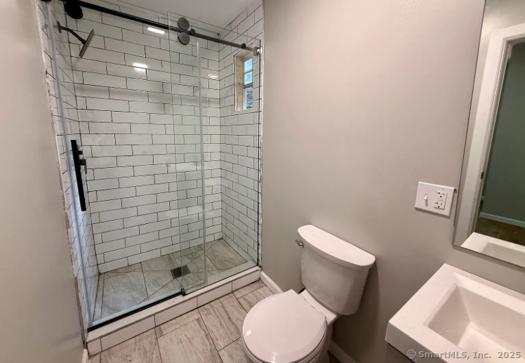 61 Field Street, Unit 211 Waterbury, CT 06702 - Photo 5 of 11 a white toilet sitting next to a bathroom sink