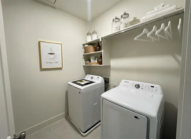 a spacious bedroom with a bed and a chandelier
