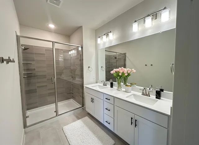 a spacious bathroom with a granite countertop sink and a mirror