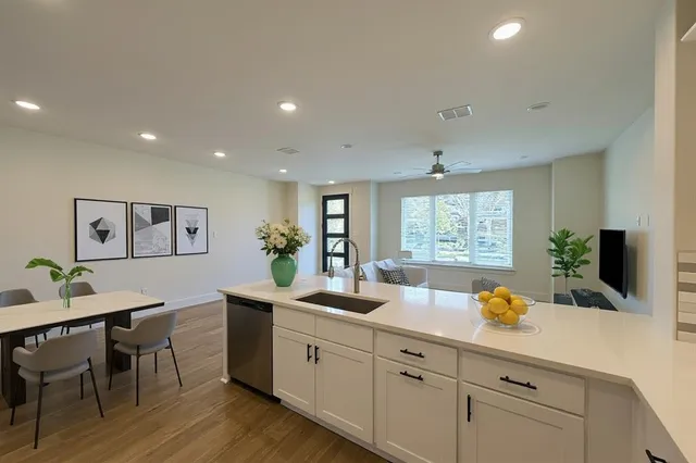a kitchen with white cabinets and stainless steel appliances