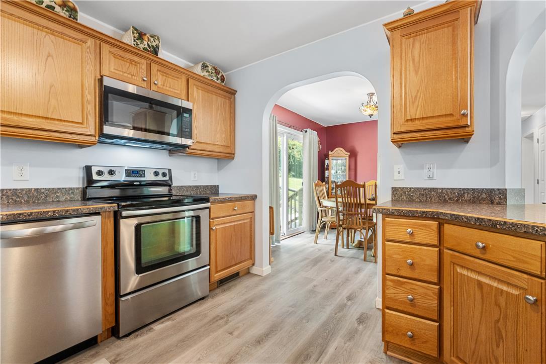 7353 Farrier Road Orefield, PA 18069 - Photo 24 of 74 Warm wood cabinetry and durable vinyl plank flooring define this functional workspace opening to dining.