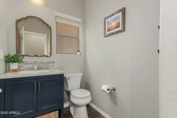 a bathroom with a toilet a sink and mirror