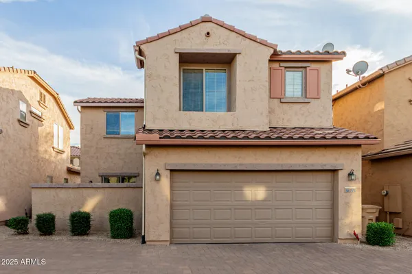 a front view of a house with garage
