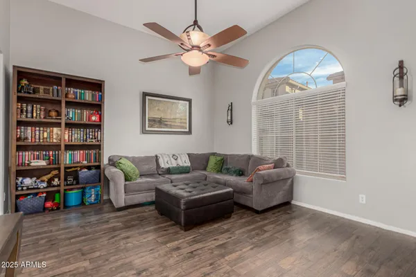 a living room with furniture and a book shelf