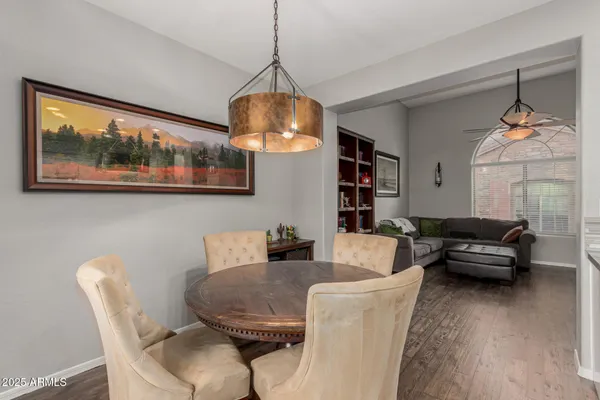 a living room with furniture a chandelier and a wooden floor