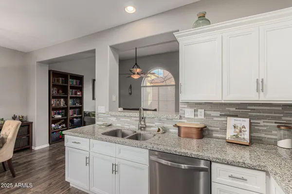 a kitchen with sink and cabinets