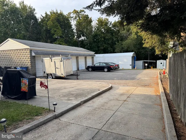 a view of a patio with a table and chairs under an umbrella