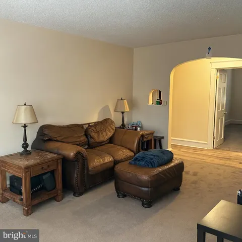 a living room with furniture and a mirror