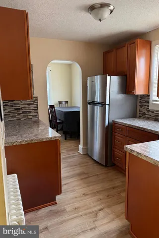 a kitchen with stainless steel appliances granite countertop a refrigerator a stove a sink and a microwave