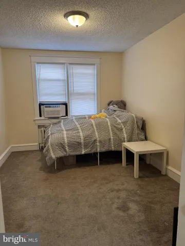 a bedroom with two beds and window