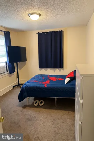 a bedroom with a bed and a chair