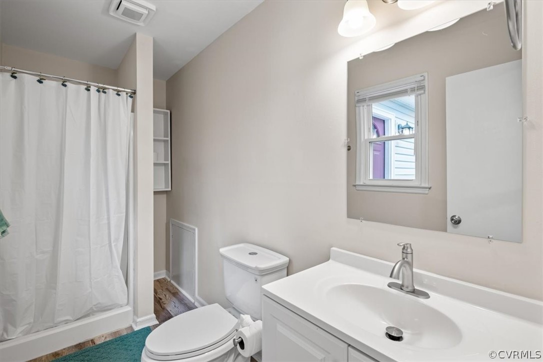 13900 Hackberry Road Chester, VA 23836 - Photo 36 of 41 a bathroom with a sink a toilet and shower curtain