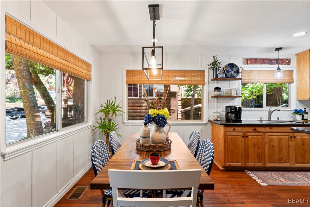 371 Maple Drive Lake Arrowhead, CA 92352 - Photo 8 of 50 a view of a dining room with furniture a chandelier and wooden floor