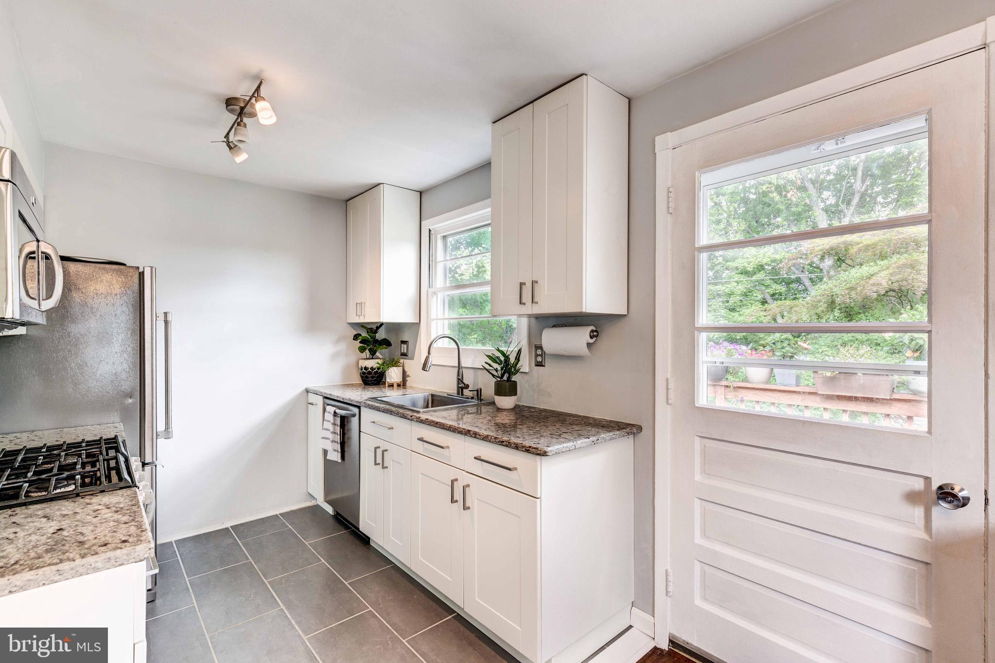 802 Templecliff Road Baltimore, MD 21208 - Photo 15 of 30 a kitchen with a stove a sink and a window