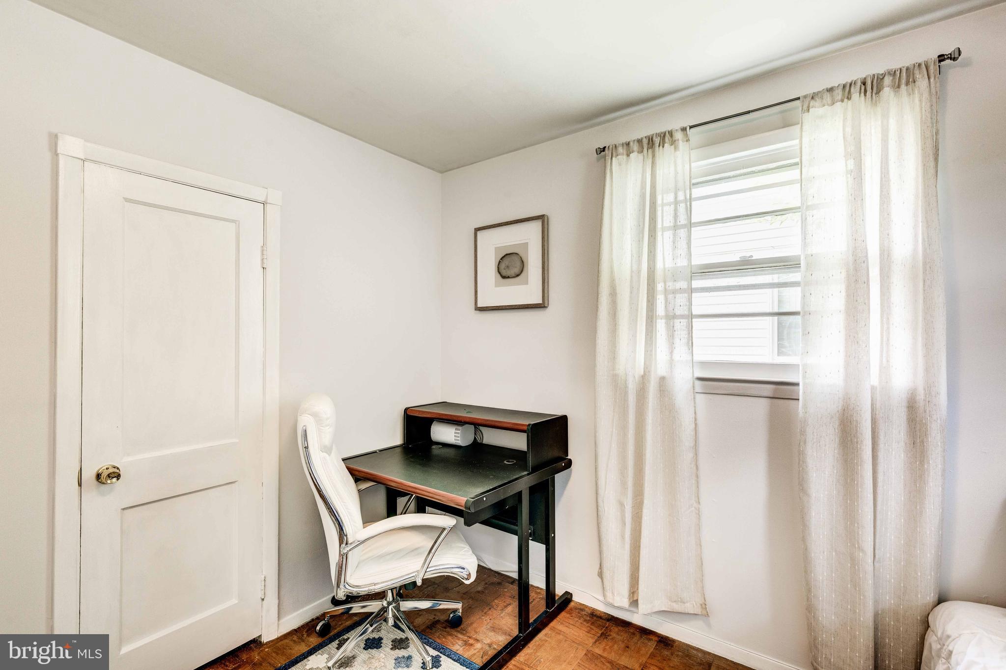 802 Templecliff Road Baltimore, MD 21208 - Photo 19 of 30 a view of a workspace with furniture and a window