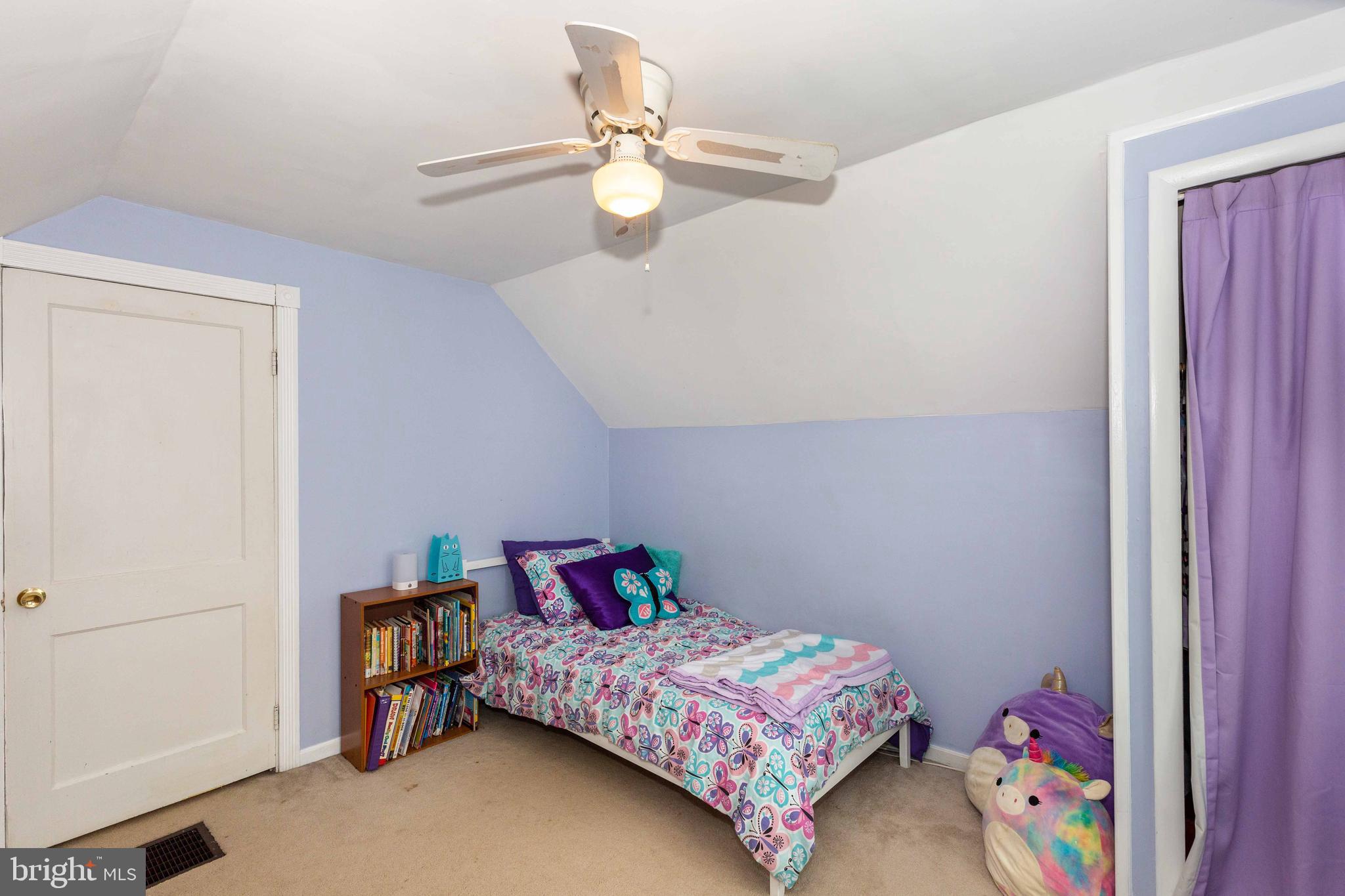 802 Templecliff Road Baltimore, MD 21208 - Photo 22 of 30 a bedroom with a bed and a chandelier