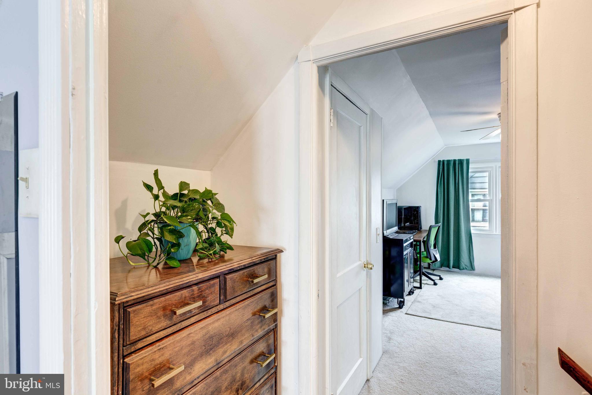 802 Templecliff Road Baltimore, MD 21208 - Photo 23 of 30 a view of a hallway with wooden floor and a dining table