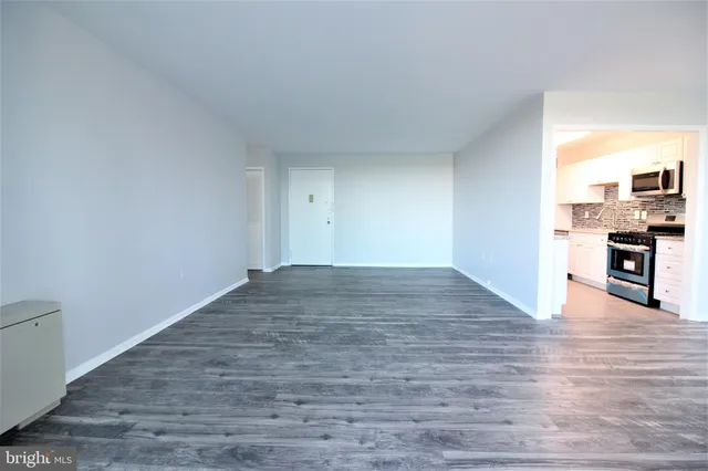 a view of a kitchen with wooden floor