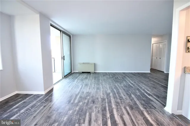 a view of a room with wooden floor and bench