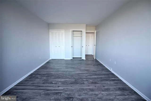 a view of room with wooden floor