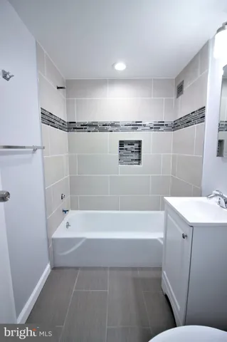a bathroom with a bathtub a shower a toilet and sink