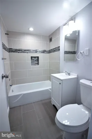 a bathroom with a toilet a sink and bathtub