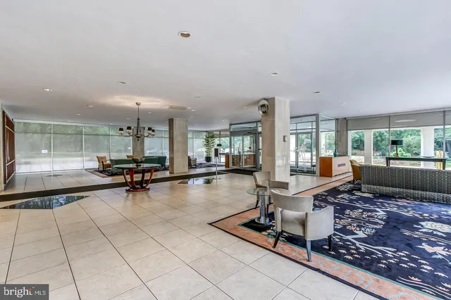 a view of a dining room with furniture a chandelier and wooden floor