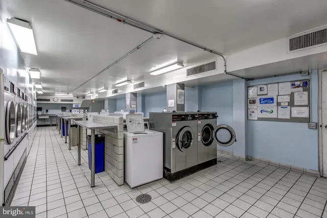 a living room with furniture and a book shelf