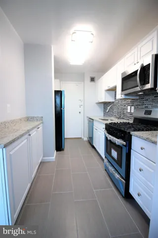a kitchen with stainless steel appliances granite countertop a stove and a sink