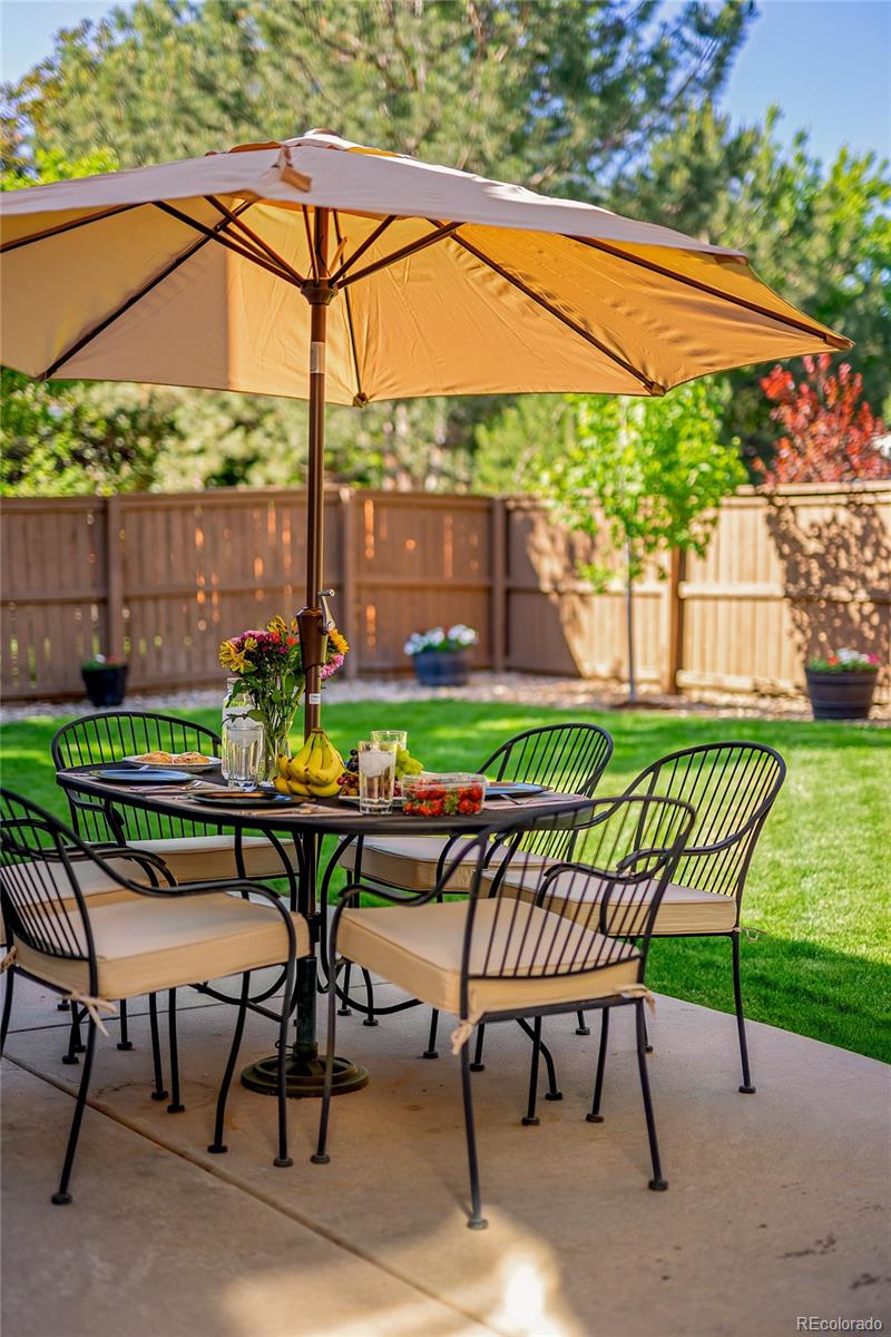 9441 South Hackberry Lane Highlands Ranch, CO 80129 - Photo 5 of 50 a view of chairs and table in backyard