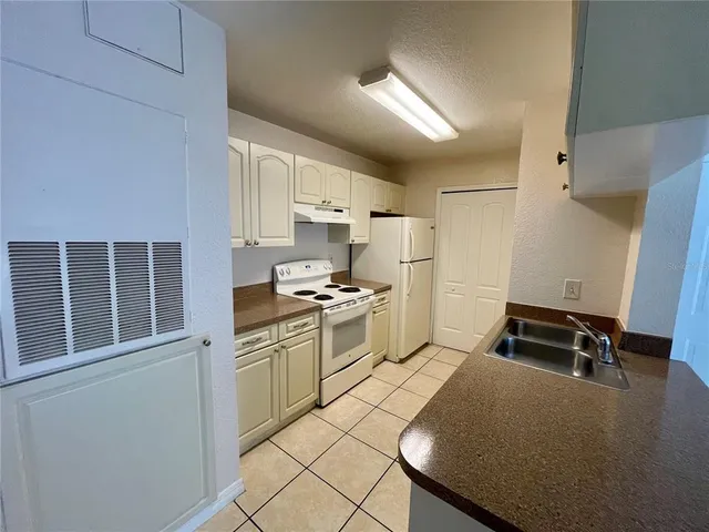 a kitchen that has a sink and a stove