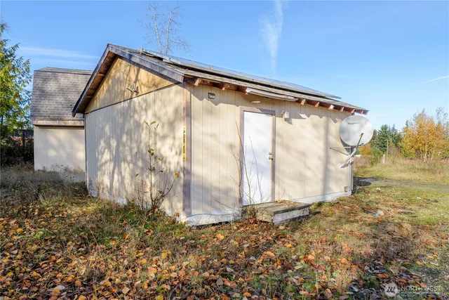 a backyard of a house with barbeque oven table and chairs