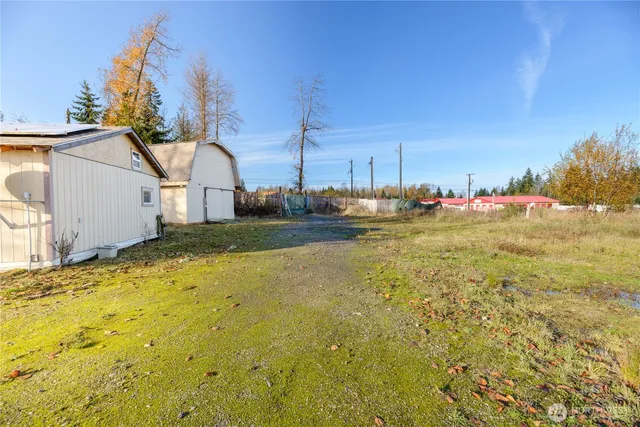 a view of a house with a yard and a trees