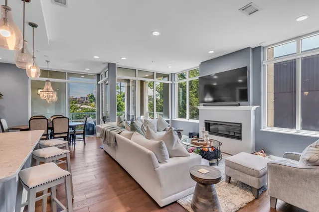a living room with fireplace furniture and a flat screen tv