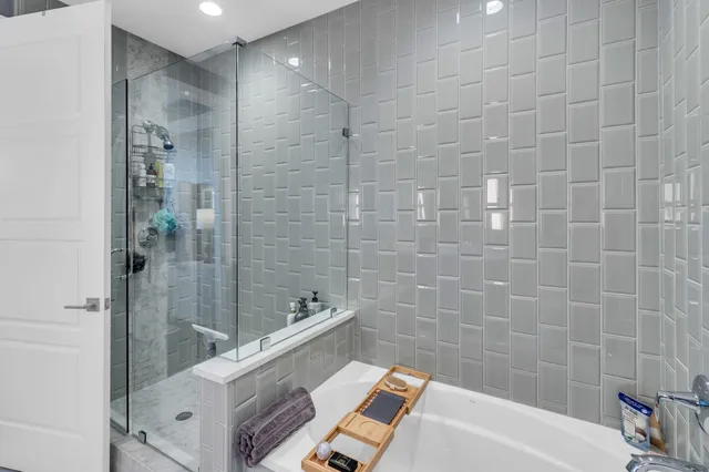 a bathroom with a bathtub and shower