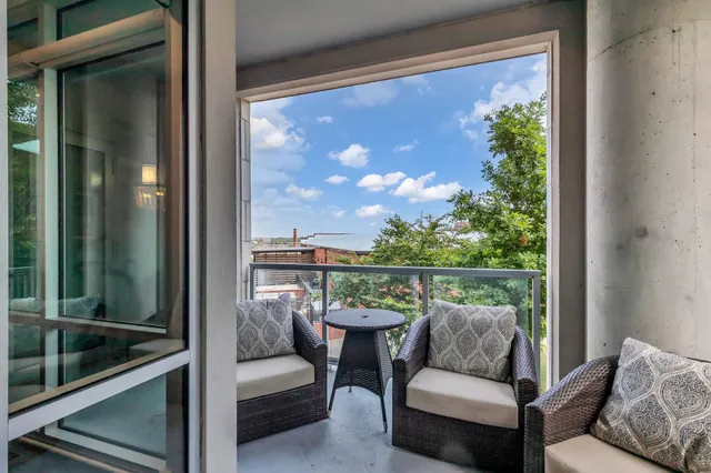 a balcony with furniture and a potted plant