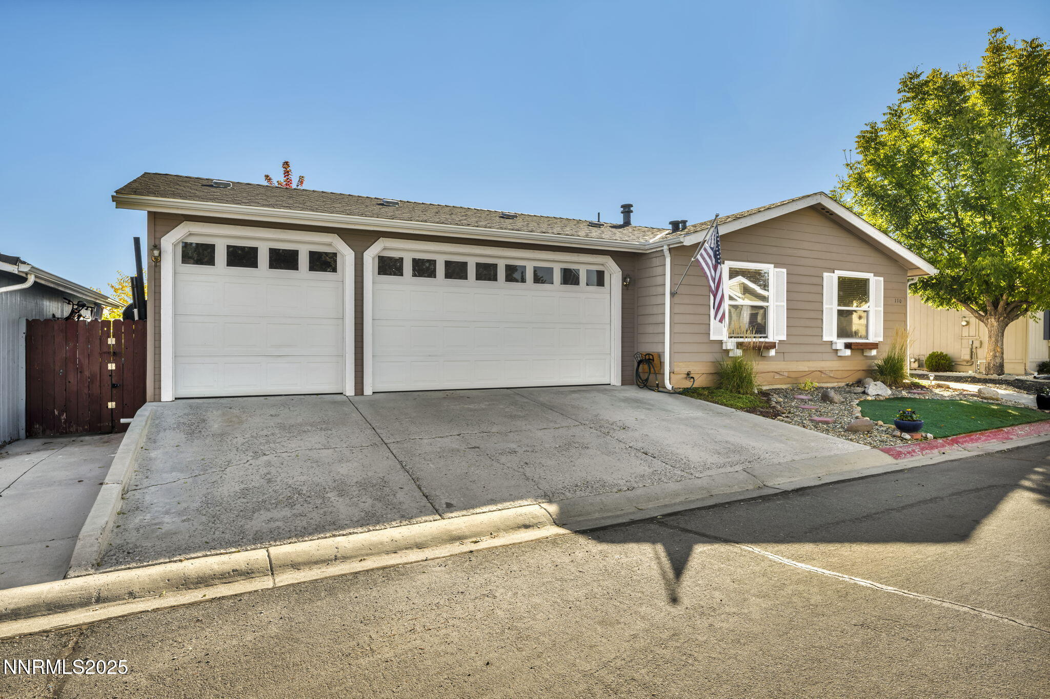110 Platinum Pointe Way Reno, NV 89506 - Photo 1 of 39 a front view of a house with garage and plants