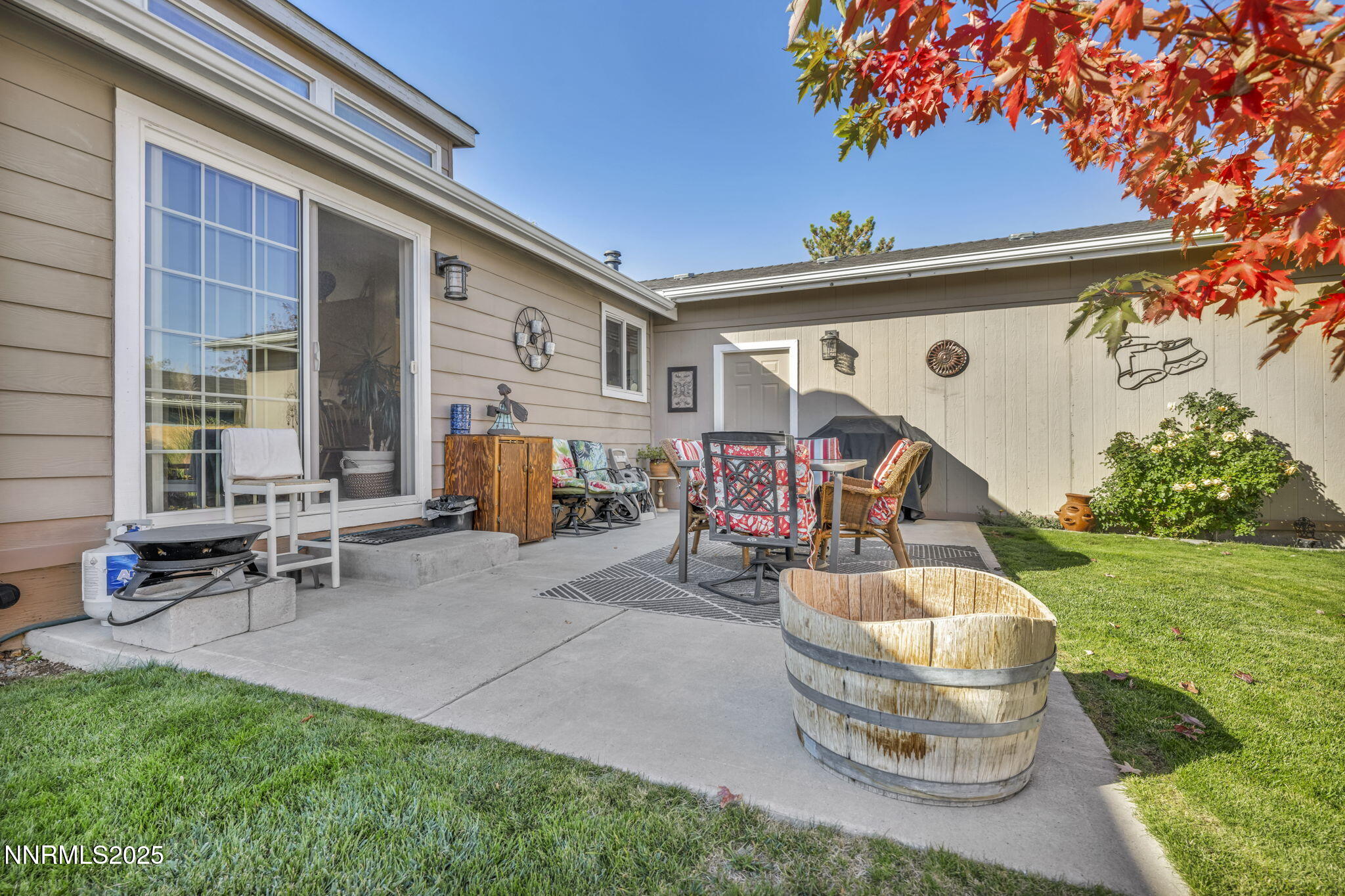 110 Platinum Pointe Way Reno, NV 89506 - Photo 11 of 39 a view of a patio with table and chairs potted plants and a large tree