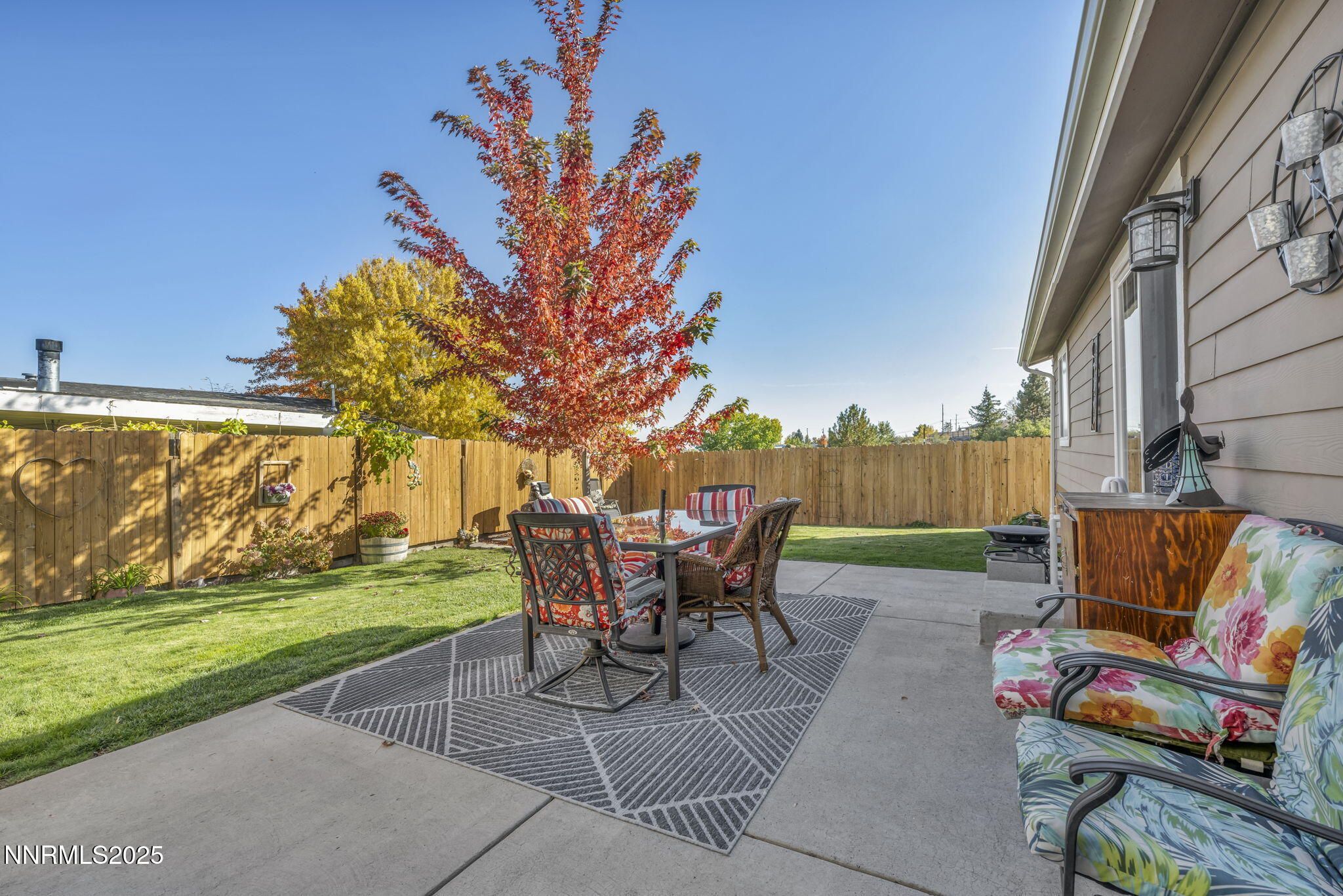 110 Platinum Pointe Way Reno, NV 89506 - Photo 14 of 39 a view of a backyard with table and chairs potted plants and a big yard