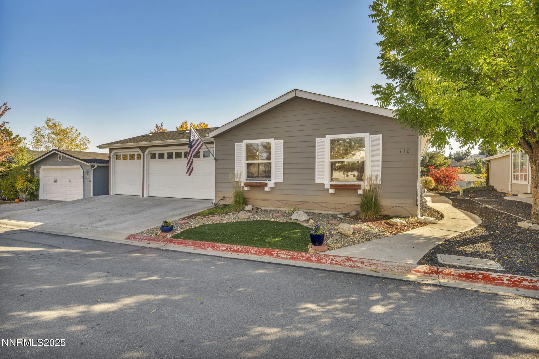 110 Platinum Pointe Way Reno, NV 89506 - Photo 3 of 39 a front view of a house with a yard and garage