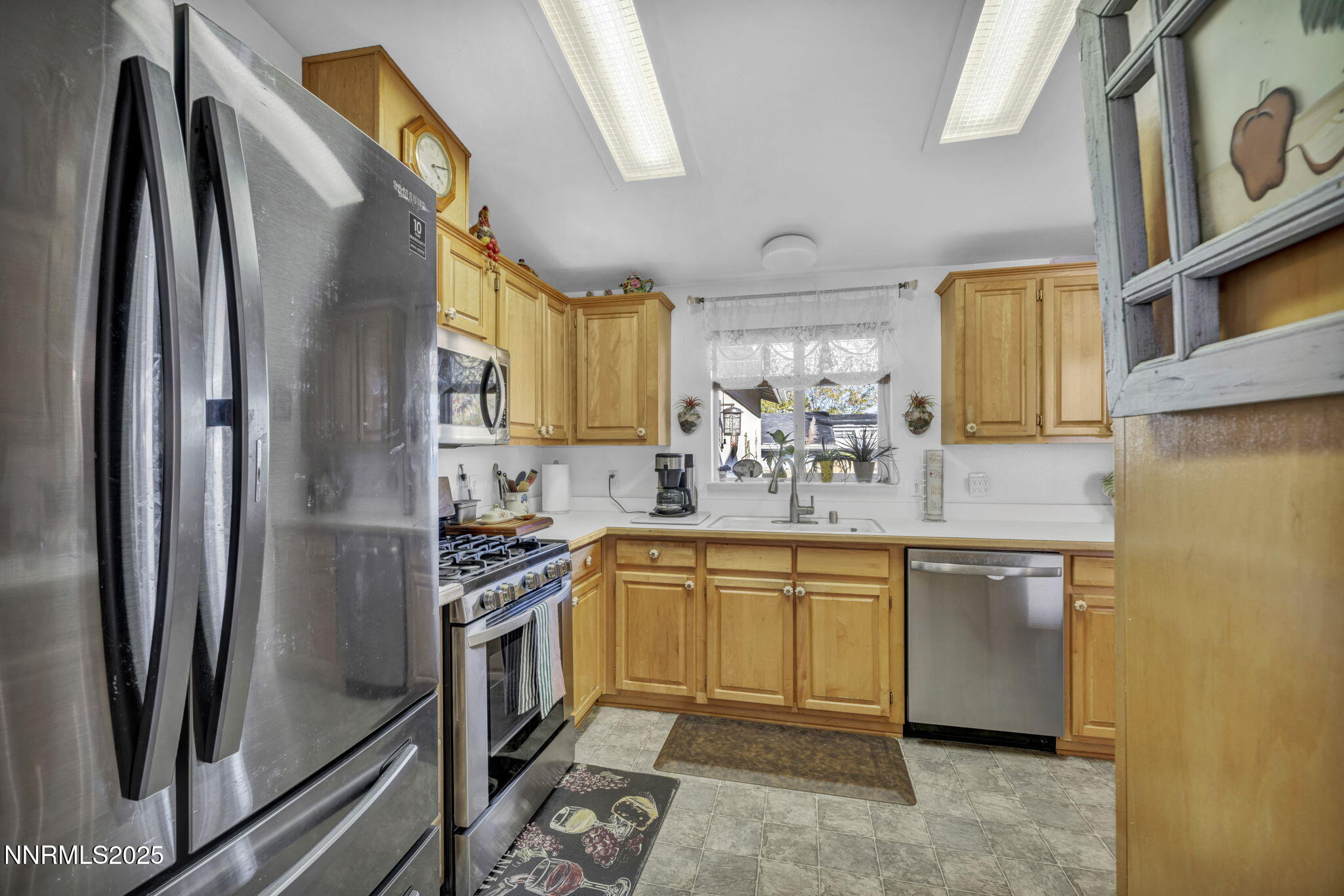 110 Platinum Pointe Way Reno, NV 89506 - Photo 39 of 39 a kitchen with stainless steel appliances granite countertop a refrigerator a stove and a sink