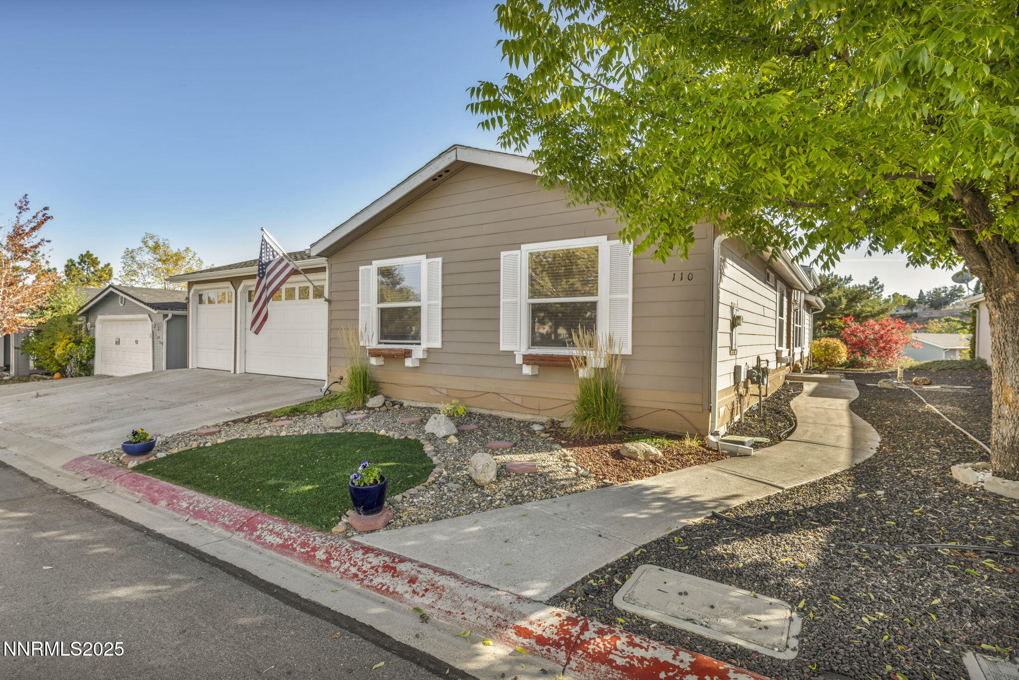 110 Platinum Pointe Way Reno, NV 89506 - Photo 4 of 39 a front view of a house with garden